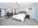 Light-filled main bedroom offers comfortable sleeping arrangements, desk area, and ceiling fan at 609 Big Pine Ave, Minneola, FL 34715