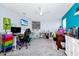 Bright bonus room ideal for a hobby or play room with a TV and a ceiling fan at 609 Big Pine Ave, Minneola, FL 34715