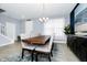 Bright dining room features a modern chandelier, a large dining table, and neutral decor at 609 Big Pine Ave, Minneola, FL 34715