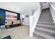 Inviting dining room with stairs, stylish decor, and adjacent kitchen at 609 Big Pine Ave, Minneola, FL 34715