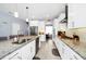 Spacious kitchen with an island, white cabinets, stainless appliances and stone countertops at 609 Big Pine Ave, Minneola, FL 34715