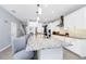 Open kitchen with white cabinets, granite countertops, and a large island with bar stool seating at 609 Big Pine Ave, Minneola, FL 34715