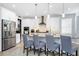 Charming kitchen island features pendant lighting, granite countertops, and seating for four at 609 Big Pine Ave, Minneola, FL 34715