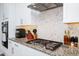Close up of a modern kitchen with stainless appliances and granite countertops at 609 Big Pine Ave, Minneola, FL 34715