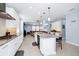 Spacious kitchen island boasts seating, pendant lighting, and overlooks the adjacent living room at 609 Big Pine Ave, Minneola, FL 34715