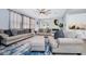 Bright living room featuring a ceiling fan, comfortable seating, and sliding glass doors at 609 Big Pine Ave, Minneola, FL 34715
