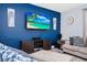 Comfortable living room features a TV and furniture set against a blue accent wall at 609 Big Pine Ave, Minneola, FL 34715