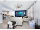 Bright and airy living room featuring a modern ceiling fan, comfortable seating, and an adjacent, open-concept kitchen area at 609 Big Pine Ave, Minneola, FL 34715