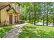 Scenic backyard view with a tranquil lake, lush green grass, and mature shade trees, offering a peaceful retreat at 6384 Raleigh St # 2214, Orlando, FL 32835