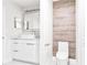 Modern bathroom features a sleek white vanity and wood-look accent wall, creating a spa-like ambiance at 6384 Raleigh St # 2214, Orlando, FL 32835