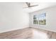 Bright bedroom with hardwood floors and ceiling fan; the natural light creates a calming space at 6384 Raleigh St # 2214, Orlando, FL 32835