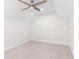 Neutral bedroom features a ceiling fan and plush carpet at 6384 Raleigh St # 2214, Orlando, FL 32835