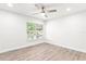 Bedroom features light-colored hardwood flooring and bright windows at 6384 Raleigh St # 2214, Orlando, FL 32835