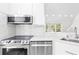 Contemporary kitchen featuring stainless steel appliances, marble backsplash, and sleek cabinetry for modern cooking at 6384 Raleigh St # 2214, Orlando, FL 32835