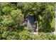 High angle shot of a roof surrounded by trees; landscape maintained with lawn and mulch at 643 Princewood Dr, Deland, FL 32724