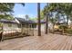 A wooden deck wraps around the backyard, providing views of the trees and lush landscape at 643 Princewood Dr, Deland, FL 32724