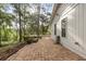 Backyard patio and deck area, surrounded by mature trees at 643 Princewood Dr, Deland, FL 32724