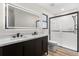 Modern bathroom featuring double vanity, illuminated mirror, and frameless glass shower at 643 Princewood Dr, Deland, FL 32724