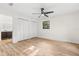 Light-filled bedroom with sleek ceiling fan, large closet, and view to bathroom at 643 Princewood Dr, Deland, FL 32724