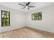 Bedroom featuring sleek ceiling fan, hardwood flooring, and black window frames at 643 Princewood Dr, Deland, FL 32724
