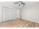 Bedroom features stylish laminate flooring, a ceiling fan and a closet at 643 Princewood Dr, Deland, FL 32724