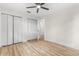 Bedroom with hardwood floors, a ceiling fan, and a large closet at 643 Princewood Dr, Deland, FL 32724