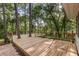 Large wooden deck surrounded by mature trees; perfect for outdoor entertaining at 643 Princewood Dr, Deland, FL 32724