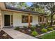 A close up of the exterior entrance showcasing stone accents and refreshed landscaping at 643 Princewood Dr, Deland, FL 32724