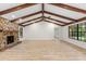 Spacious living room featuring a striking stone fireplace and wood-beamed ceilings at 643 Princewood Dr, Deland, FL 32724