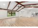 Bright and airy living room with beamed ceiling, flowing into a modern kitchen at 643 Princewood Dr, Deland, FL 32724