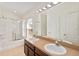 Bathroom featuring double sinks, a shower over tub and a large mirror at 6484 S Goldenrod Rd # 41A, Orlando, FL 32822