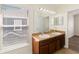 Bright bathroom features double sinks, large mirror, and natural light from the window at 6484 S Goldenrod Rd # 41A, Orlando, FL 32822