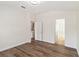 Bright bedroom featuring hardwood floors, access to a closet, and an ensuite bathroom at 6484 S Goldenrod Rd # 41A, Orlando, FL 32822