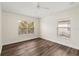 This bright bedroom offers wood flooring and two windows, creating a comfortable and inviting space at 6484 S Goldenrod Rd # 41A, Orlando, FL 32822