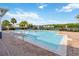 The sparkling community pool offers lounge chairs and beautiful views of the lake and trees at 6484 S Goldenrod Rd # 41A, Orlando, FL 32822