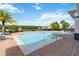The community pool area features comfortable lounge chairs, palm trees, and lake views at 6484 S Goldenrod Rd # 41A, Orlando, FL 32822