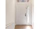 Bright foyer with a white front door featuring decorative sidelights and a transom window at 6484 S Goldenrod Rd # 41A, Orlando, FL 32822