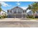 Stylish townhome featuring a gray exterior, multiple garage doors, and quaint second-story balconies at 6484 S Goldenrod Rd # 41A, Orlando, FL 32822