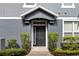 Charming entryway with a gray door framed by manicured bushes and a decorative transom window at 6484 S Goldenrod Rd # 41A, Orlando, FL 32822