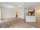 Open-concept living space with wood flooring, a modern chandelier, and seamless flow to the kitchen area at 6484 S Goldenrod Rd # 41A, Orlando, FL 32822