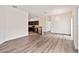 Open-concept living room with hardwood floors leads to the kitchen with stainless steel appliances at 6484 S Goldenrod Rd # 41A, Orlando, FL 32822