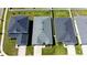 A high angle view shows the roof and yards of the houses in the neighborhood at 7 Polermo Ave, St Cloud, FL 34771