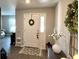 Inviting foyer showcasing a white front door with wreath and a decoratively-appointed interior at 7 Polermo Ave, St Cloud, FL 34771