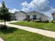 Beautiful one-story home with vibrant landscaping and a well-manicured lawn at 7 Polermo Ave, St Cloud, FL 34771