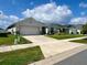 Row of well-maintained homes, each with a two-car garage, and lush green lawns at 7 Polermo Ave, St Cloud, FL 34771