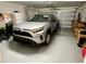 Clean and tidy garage offers ample space for parking and storage, plus a white refrigerator at 7 Polermo Ave, St Cloud, FL 34771