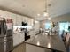 Contemporary kitchen featuring white cabinets, stainless steel appliances, and a spacious island with seating at 7 Polermo Ave, St Cloud, FL 34771