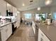 Bright kitchen featuring modern appliances, white cabinetry, and a view into the adjacent dining area at 7 Polermo Ave, St Cloud, FL 34771