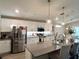 Modern kitchen featuring stainless steel appliances, white cabinets, and a large kitchen island at 7 Polermo Ave, St Cloud, FL 34771