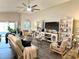 Bright living room features vaulted ceilings, a ceiling fan, stylish decor, and wood-look floors at 7 Polermo Ave, St Cloud, FL 34771